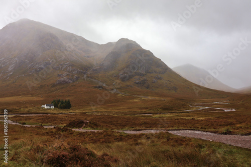 Lagangarbh Cottage “Wee White House” beneath Buachaille Etive Mòr in River Coupall landscape scene; charming Scottish Highlands hut beside flowing river, autumn mountain backdrop in Glencoe, Scotland
