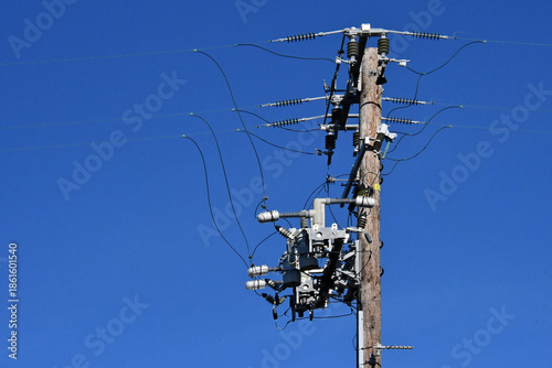 Valokuva Old telephone pole completely retrofitted with new strain insulators, radio cont