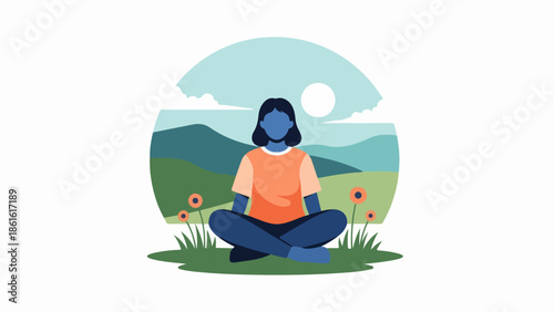 Woman in orange shirt meditating on grassy field with red flowers and mountains in background