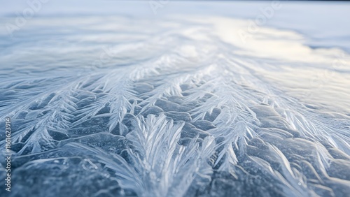Frosty patterns on frozen water surface with ice crystals forming intricate designs