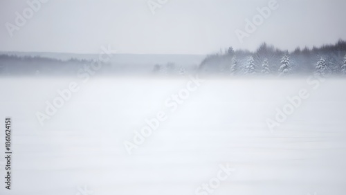 A serene winter landscape with foggy lake and trees in the distance viewed from a calm environment
