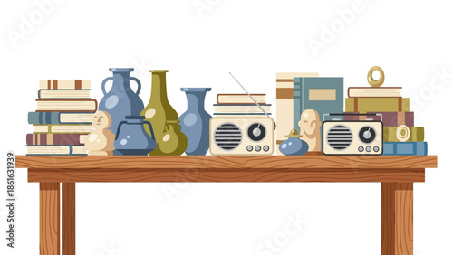 Vintage objects and books on wooden table with retro radios and ceramic vases