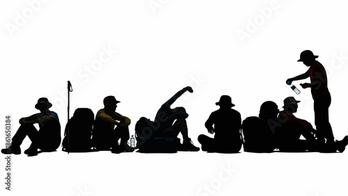 Silhouette of hikers resting during a journey with backpacks.
