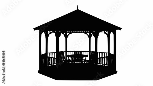 Silhouette of a wooden gazebo with chairs and table.