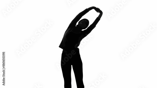 Silhouette of a woman stretching her arms and body.