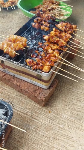 The pleasure of grilling chicken satay over hot coals