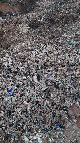 4K Vertical aerial view of garbage site in the vicinity of the city