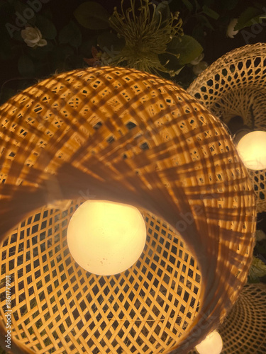 A close-up photograph of woven handcrafted objects showing circular patterns, interlaced structure, and decorative design details.