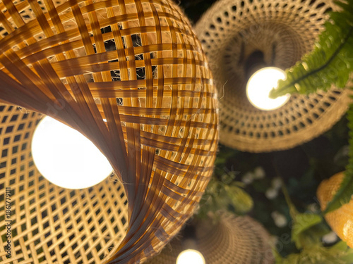 A close-up photograph of woven handcrafted objects showing circular patterns, interlaced structure, and decorative design details.