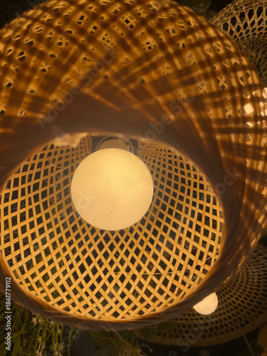 A close-up photograph of woven handcrafted objects showing circular patterns, interlaced structure, and decorative design details.
