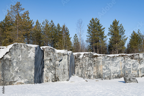 Fragment of cut marble rock in the old Italian marble quarry. Ruskeala Mountain Park. Karelia, Russia