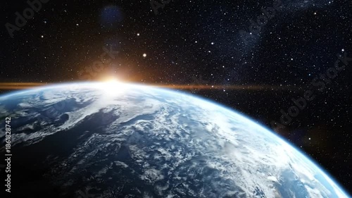 Epic Earth view with sunrise over the planet against a star filled background representing space and the universe