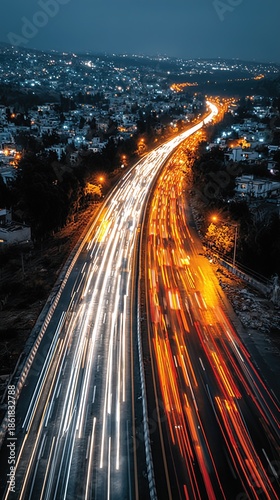 Aerial Night View of City Highway, Long Exposure Car Light Trails, Urban Motion and Energy for Traffic Planning or City Promotion Background