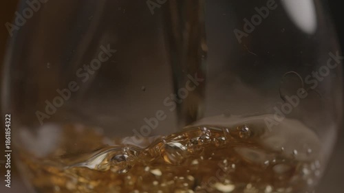 Glass being filled with with liquor