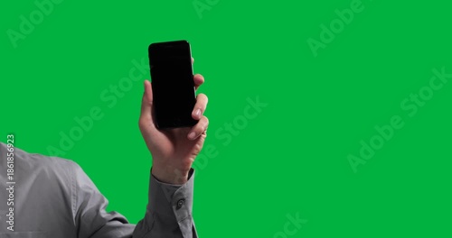 Adult male hand holding smartphone against transparent background, displaying technology graphics