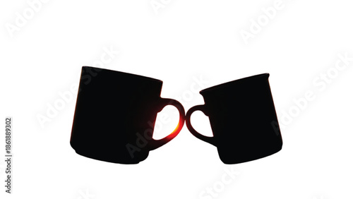 Two black mugs clinking with sunset glow silhouette