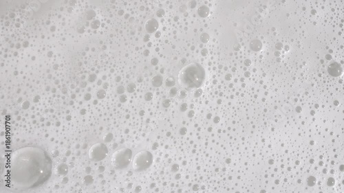 Texture of white soap foam with bubbles abstract background. Soap sud macro structure. Bathtup Soap Foam. Natural White Shampoo Bubbles Motion. High quality 4k footage
