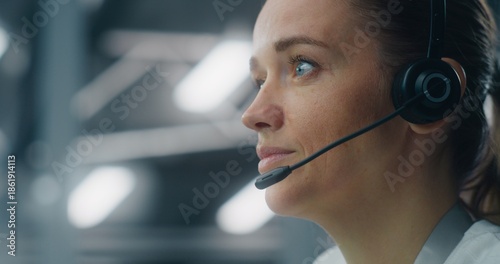 Close Up of Dedicated Female Technician Responding to Real Time System Alerts, Communicating Via Headset at Console in Data Center. Concept of Critical Incident Management and Rapid Response.