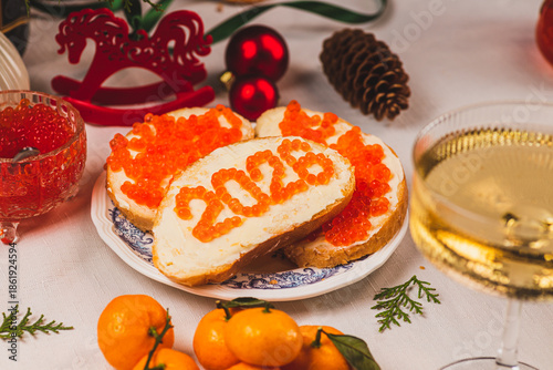 A sandwich with butter and caviar. The figures for 2026 are laid out in dots.