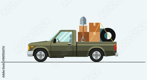Olive green pickup truck loaded with moving boxes and gardening tools.