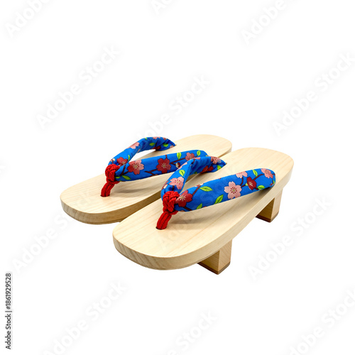 A pair of traditional Japanese geta sandals, photographed from a slightly elevated angle, showcasing their distinct design. The geta are crafted from light-colored, natural wood with a visible grain, 
