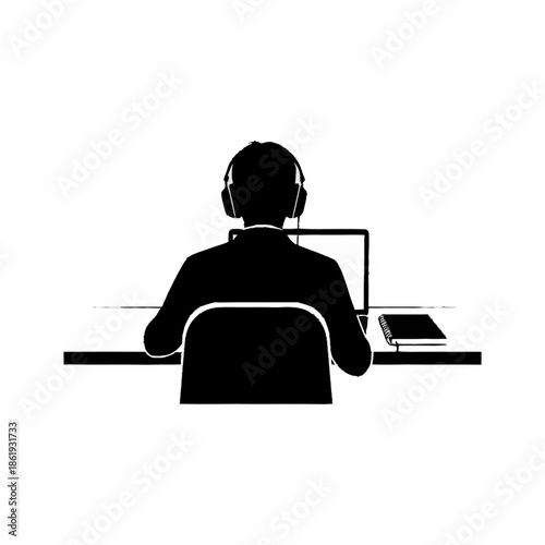 Man Wearing Headphones Sitting at Desk.