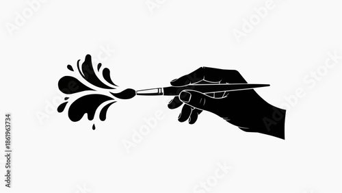 Hand holding paintbrush creating dynamic black paint splatter