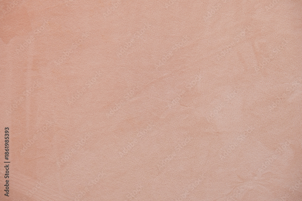 Fototapeta premium Soft warm beige textured background with subtle plaster wall surface. Minimal neutral backdrop with gentle tones, ideal for web design, branding, packaging, social media or print layouts.