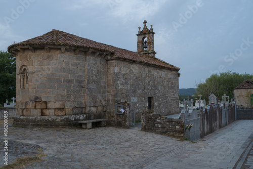 Traditional rural stone house with wooden gallery and slate roof
