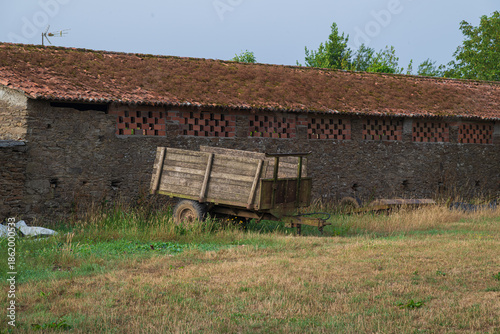 Traditional rural stone house with wooden gallery and slate roof