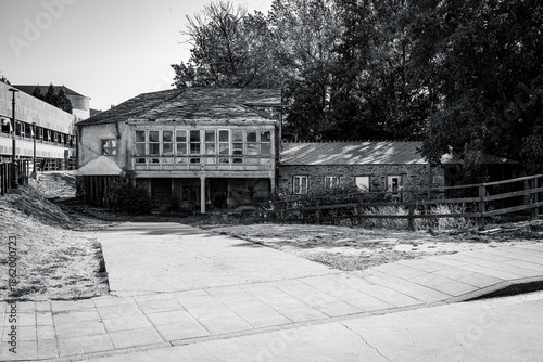 Traditional rural stone house with wooden gallery and slate roof