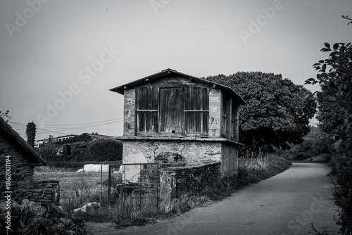 Traditional rural stone house with wooden gallery and slate roof