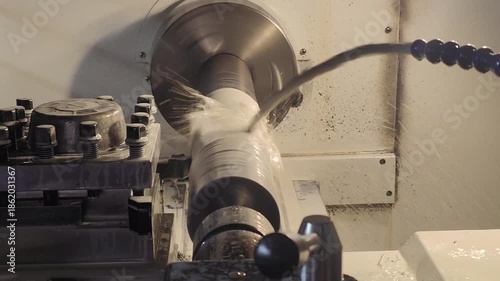 a lathe machining a big piece of metal at horizontal composition