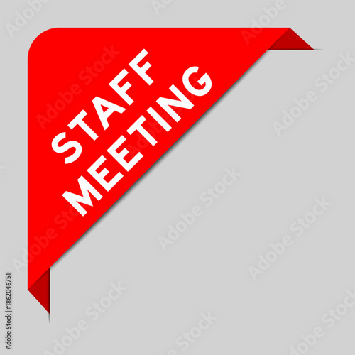 Red color of corner label banner with word staff meeting on gray background
