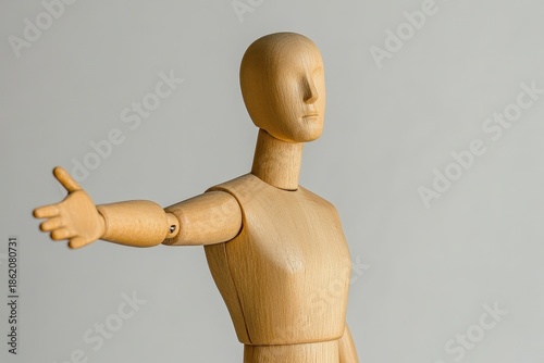 Wooden mannequin figure extending a welcoming hand.