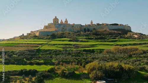 Mdina city, old capital of Malta island. Drone view of green countryside, fields 