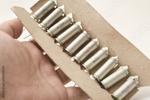 Old capacitors in paper packaging. Aluminum capacitors for electronic devices.