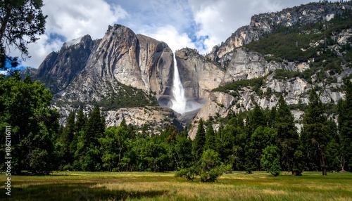 Majestic Yosemite Falls Cascading Amidst Lush Green Forest and Towering Granite Cliffs.