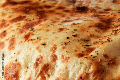 Close Up of Golden Brown Baked Flatbread Crust with Dried Herbs Texture