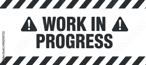 A striking black and white sign declares work in progress with bold lettering and caution symbols