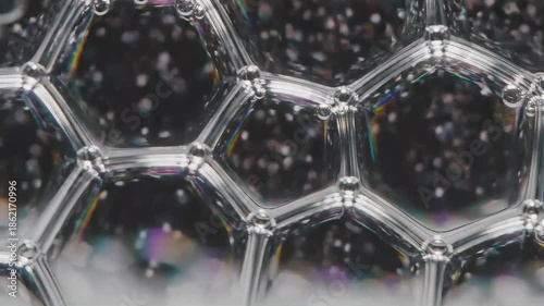Close up view of iridescent soap bubbles forming a delicate connected surface