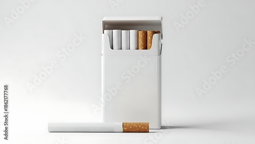 A white cigarette box with a few cigarettes and one on the ground