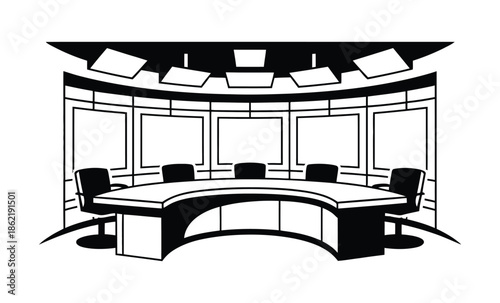 News studio desk setup features multiple monitors and empty chairs.