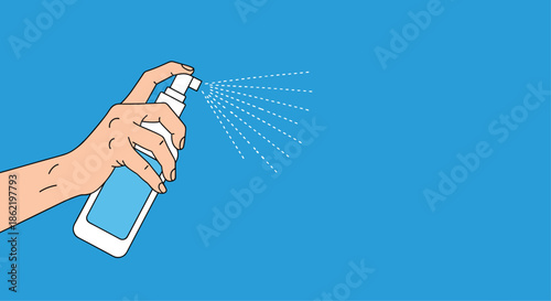 Hand holding a spray bottle against a blue background to illustrate cleaning, disinfection, or sanitizing actions.