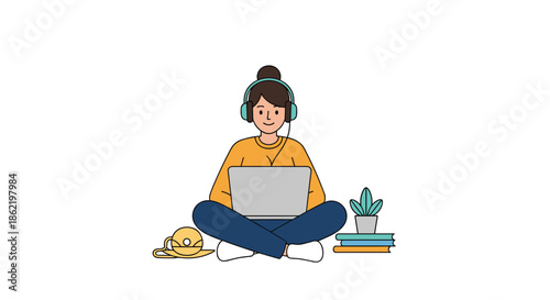 Young woman sitting cross-legged on the floor wearing headphones and working on her laptop with a stack of books and a plant nearby.