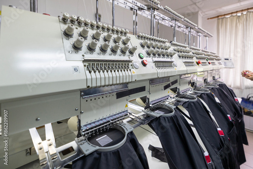 Professional embroidery machine heads stitching black fabric