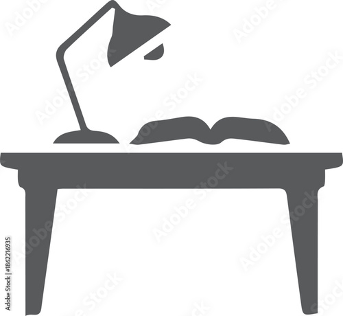 Simple icon of a study desk with a lamp and open book