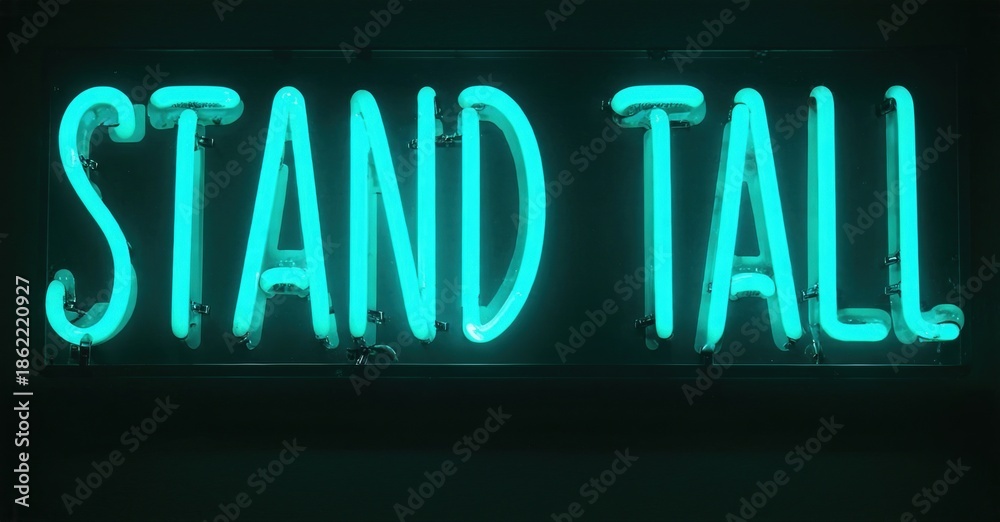 Obraz premium Bright turquoise neon sign displays words stand tall. Dark background emphasizes glowing text. Simple, motivational message.