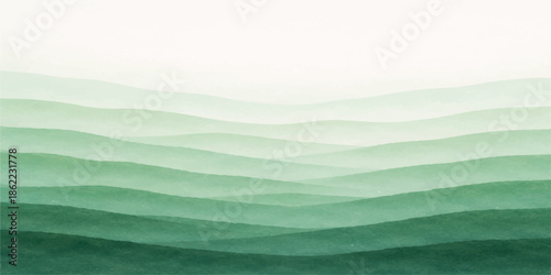 Summer mountain landscape with green grass and meadow under a cloudy sky at sunset featuring rolling hills and a distant horizon view of nature