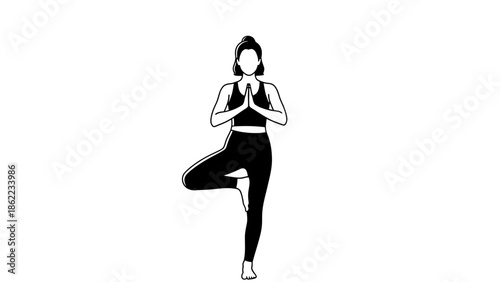 Woman practicing yoga in tree pose with hands together